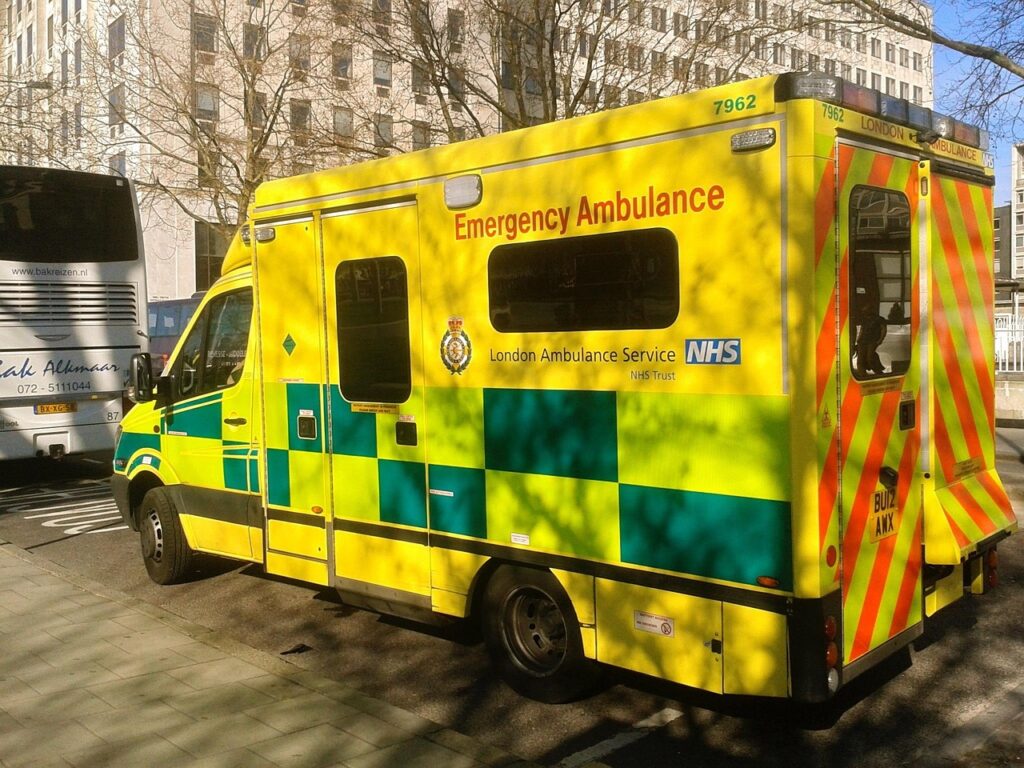 London Ambulance Service NHS emergency ambulance parked on a city street.